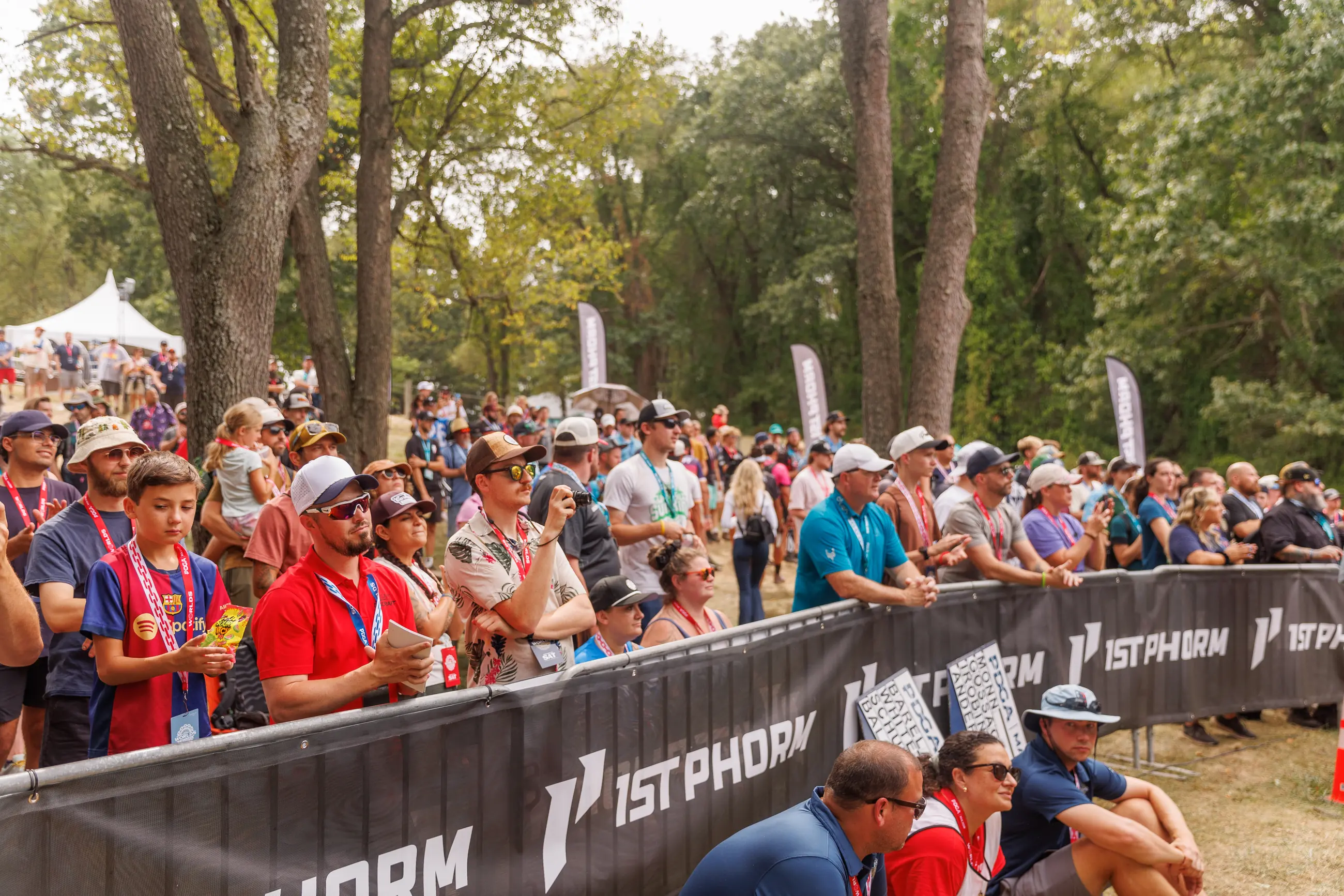 Championship sporting event with a large gallery and visible sponsor signage