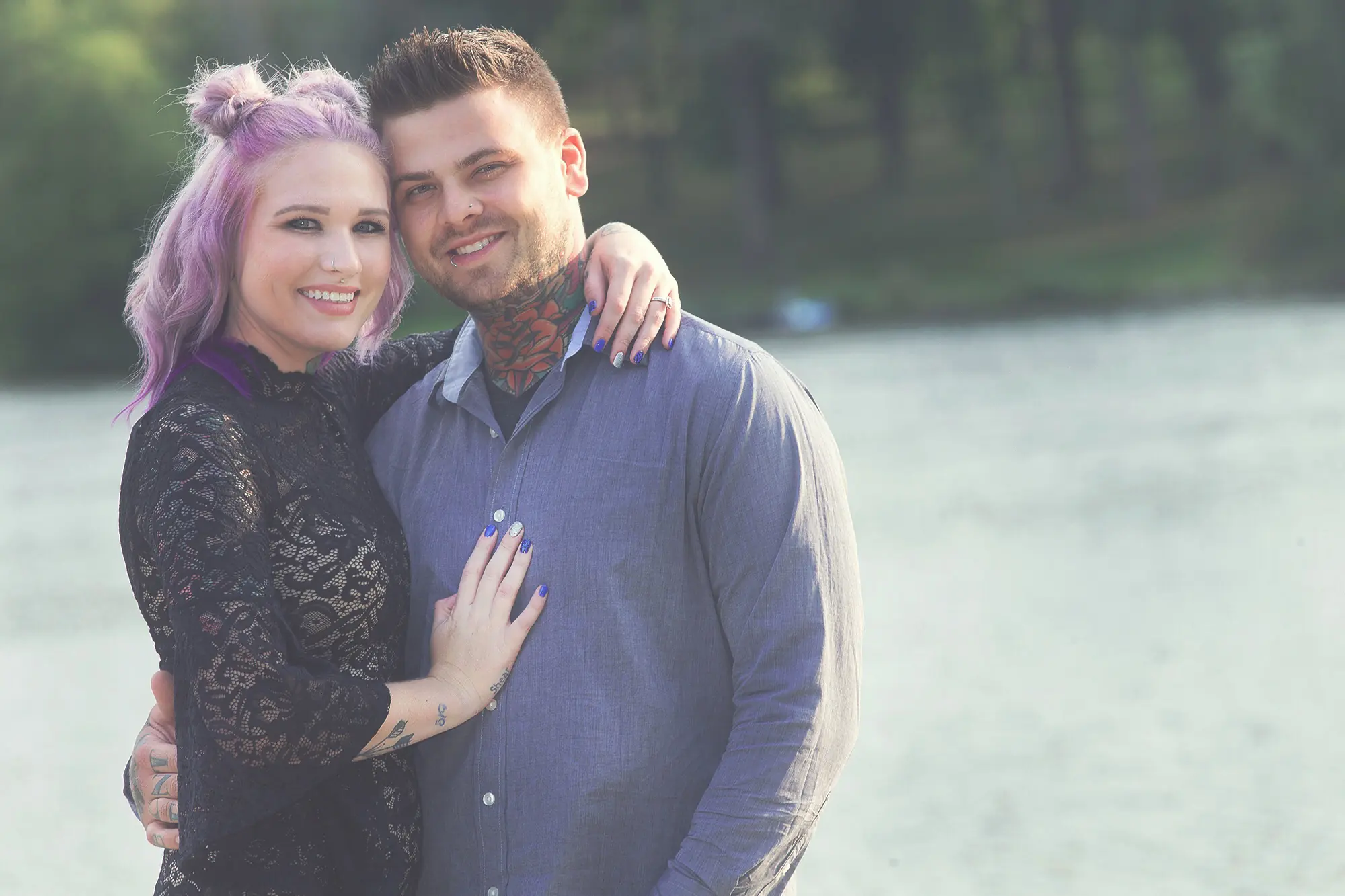 Engagement portrait of a couple beside the water
